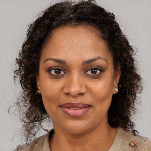 Joyful black young-adult female with medium  brown hair and brown eyes