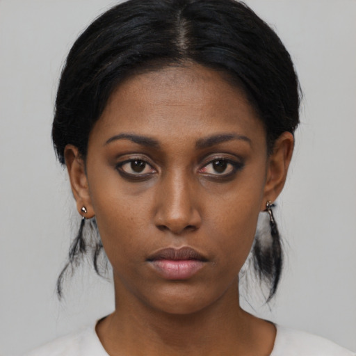 Neutral black young-adult female with medium  black hair and brown eyes