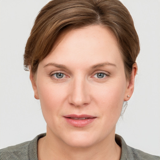 Joyful white young-adult female with short  brown hair and grey eyes