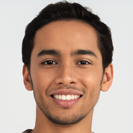 Joyful latino young-adult male with short  brown hair and brown eyes