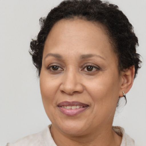 Joyful black adult female with short  brown hair and brown eyes