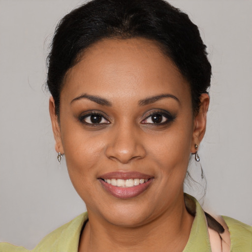 Joyful latino young-adult female with short  brown hair and brown eyes