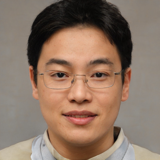 Joyful asian adult male with short  brown hair and brown eyes