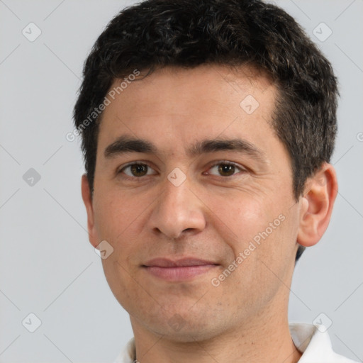 Joyful white young-adult male with short  black hair and brown eyes