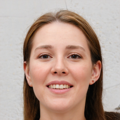 Joyful white young-adult female with long  brown hair and grey eyes