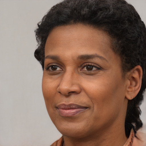 Joyful latino adult female with short  black hair and brown eyes