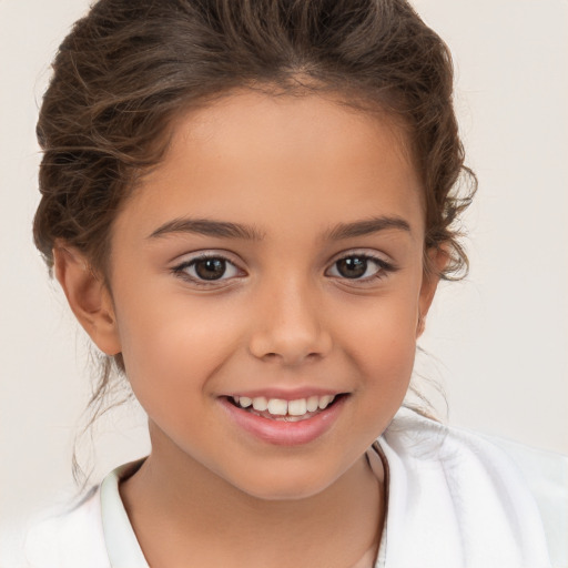 Joyful white child female with short  brown hair and brown eyes