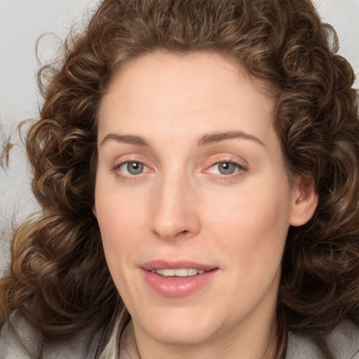 Joyful white young-adult female with long  brown hair and green eyes