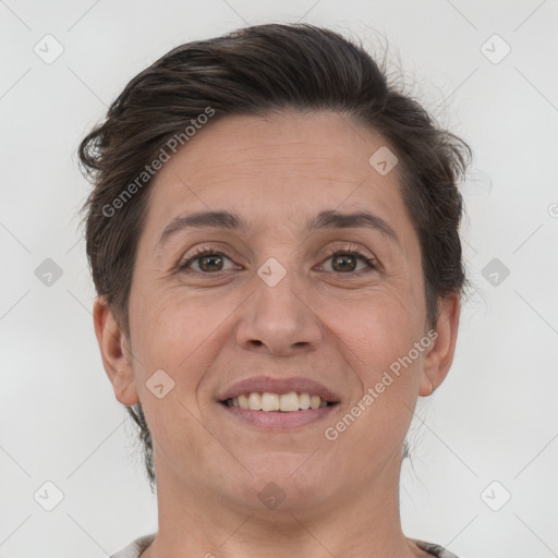 Joyful white adult female with short  brown hair and brown eyes