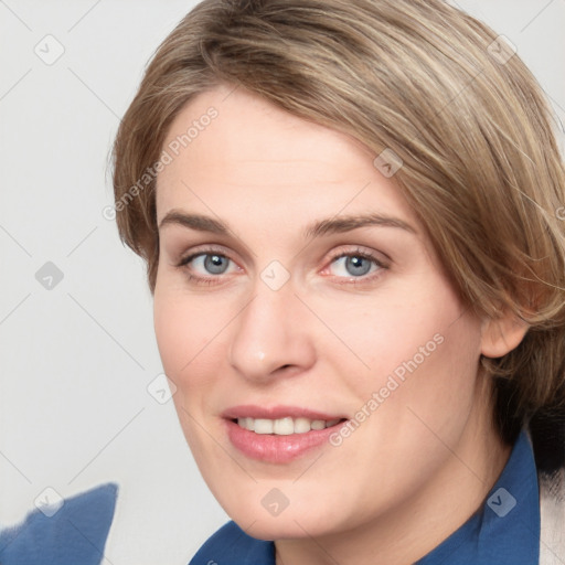 Joyful white young-adult female with medium  brown hair and blue eyes