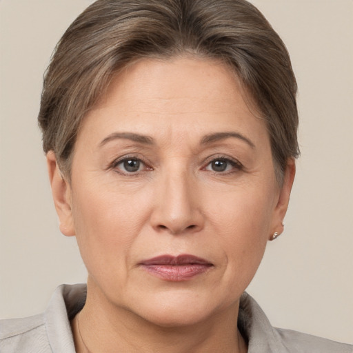 Joyful white adult female with short  brown hair and brown eyes