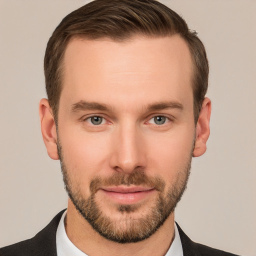 Joyful white young-adult male with short  brown hair and grey eyes