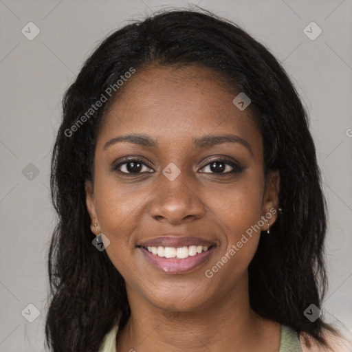 Joyful black young-adult female with long  brown hair and brown eyes