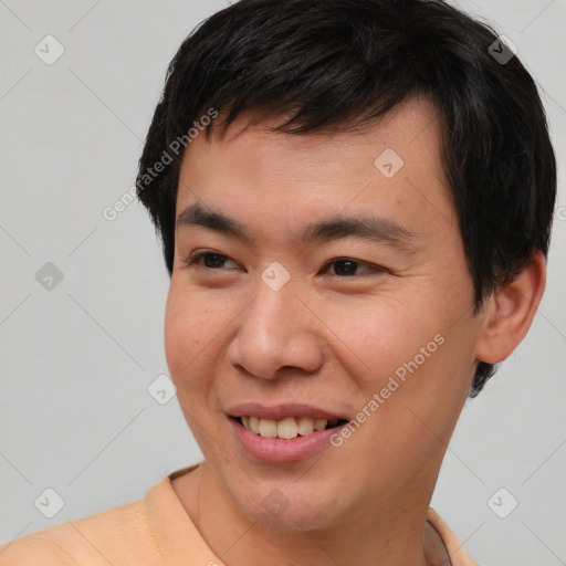 Joyful asian young-adult male with short  brown hair and brown eyes