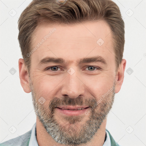 Joyful white adult male with short  brown hair and brown eyes