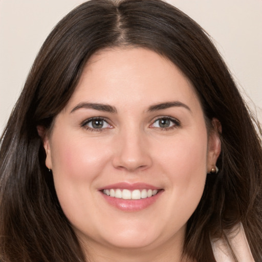 Joyful white young-adult female with long  brown hair and brown eyes