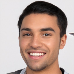 Joyful white young-adult male with short  black hair and brown eyes