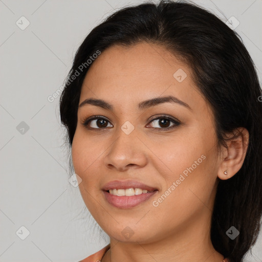 Joyful latino young-adult female with long  brown hair and brown eyes