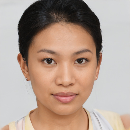 Joyful asian young-adult female with short  brown hair and brown eyes