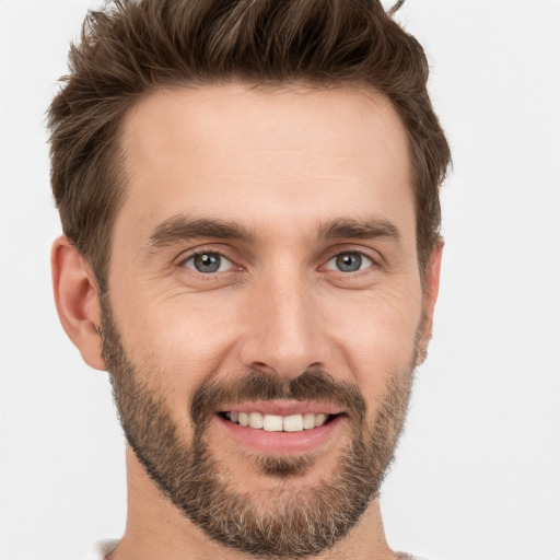 Joyful white young-adult male with short  brown hair and brown eyes