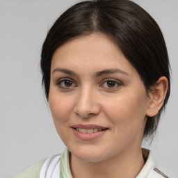 Joyful white young-adult female with medium  brown hair and brown eyes