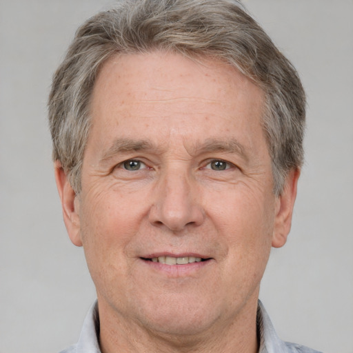 Joyful white middle-aged male with short  brown hair and grey eyes