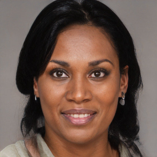 Joyful black young-adult female with medium  black hair and brown eyes