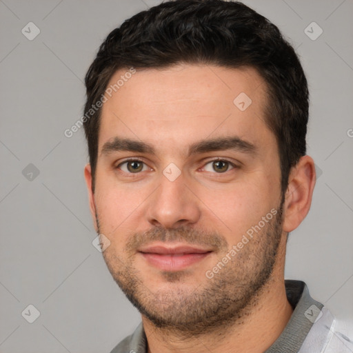 Joyful white young-adult male with short  black hair and brown eyes