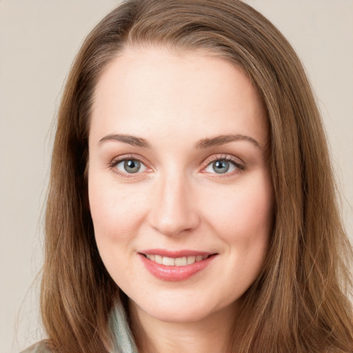 Joyful white young-adult female with long  brown hair and blue eyes