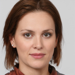 Joyful white young-adult female with medium  brown hair and blue eyes