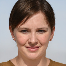 Joyful white adult female with medium  brown hair and grey eyes