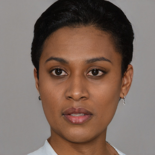 Joyful black young-adult female with short  black hair and brown eyes