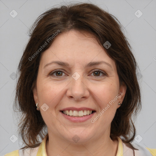 Joyful white adult female with medium  brown hair and brown eyes