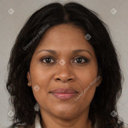 Joyful black adult female with long  brown hair and brown eyes
