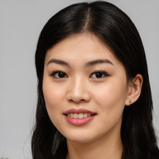Joyful asian young-adult female with long  black hair and brown eyes