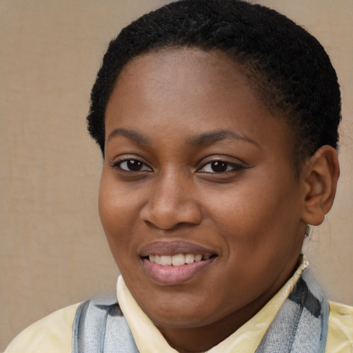 Joyful black young-adult female with short  brown hair and brown eyes