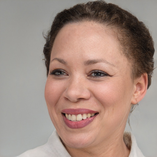 Joyful white adult female with short  brown hair and brown eyes