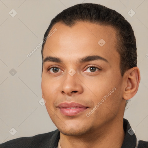 Joyful white young-adult male with short  black hair and brown eyes