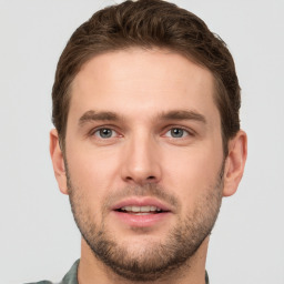 Joyful white young-adult male with short  brown hair and grey eyes