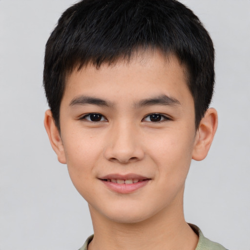 Joyful white child male with short  brown hair and brown eyes