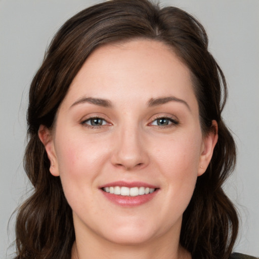 Joyful white young-adult female with medium  brown hair and blue eyes