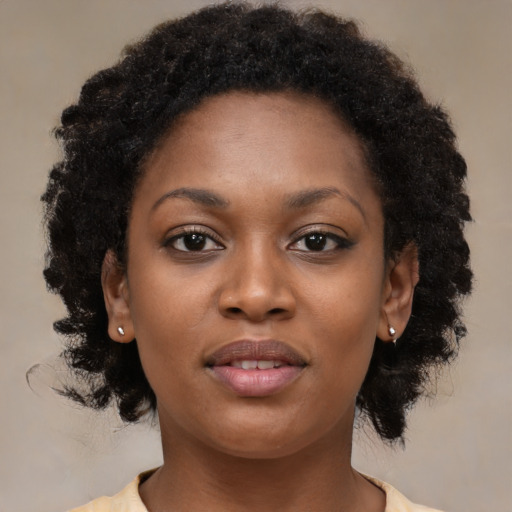 Joyful black young-adult female with medium  brown hair and brown eyes