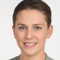 Joyful white young-adult female with short  brown hair and grey eyes