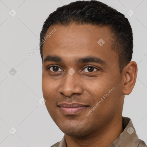 Joyful black young-adult male with short  black hair and brown eyes