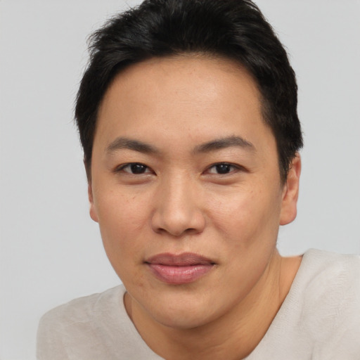 Joyful asian adult female with short  black hair and brown eyes
