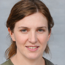 Joyful white young-adult female with medium  brown hair and blue eyes