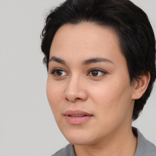 Joyful white young-adult female with medium  black hair and brown eyes