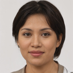 Joyful asian adult female with medium  brown hair and brown eyes