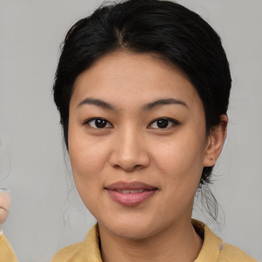 Joyful latino young-adult female with medium  brown hair and brown eyes