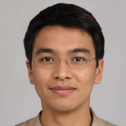 Joyful asian young-adult male with short  black hair and brown eyes